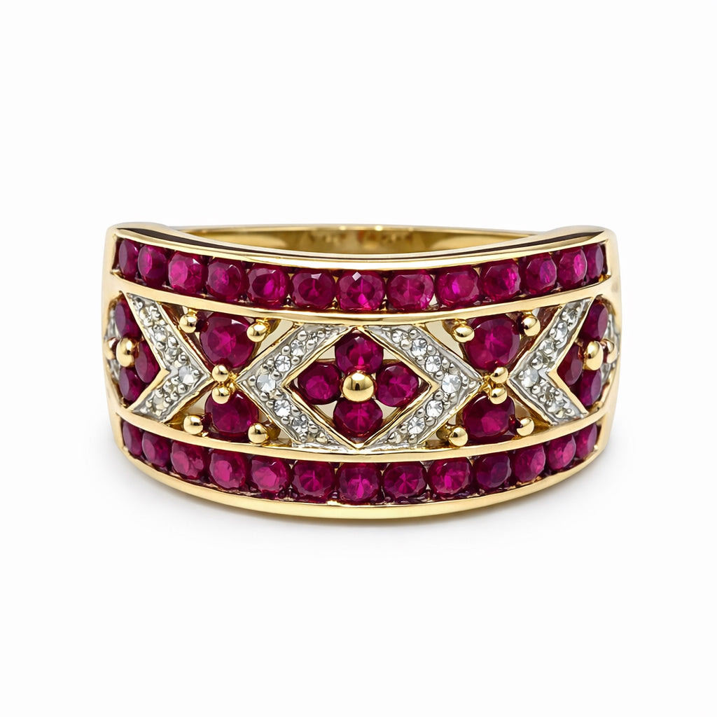 Gold ring with red gemstones and diamond accents on a white background