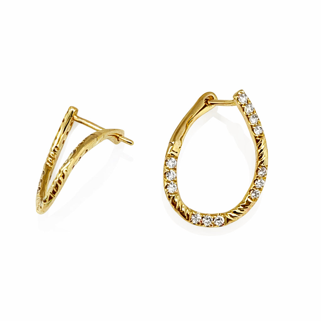 Gold hoop earrings with diamond accents on a white background