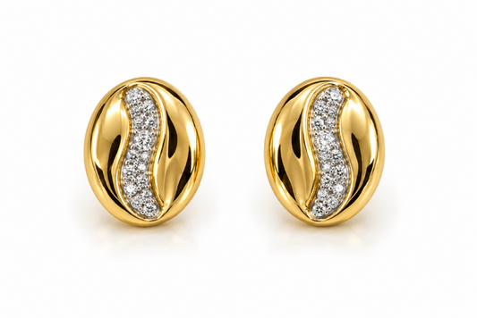 A pair of oval gold stud earrings with a polished S-shaped channel set with pavé diamonds on a clean white background.