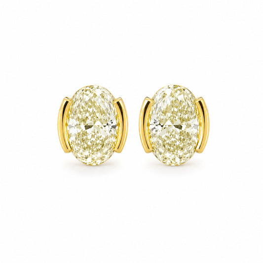 Gold earrings with large gemstones on a white background