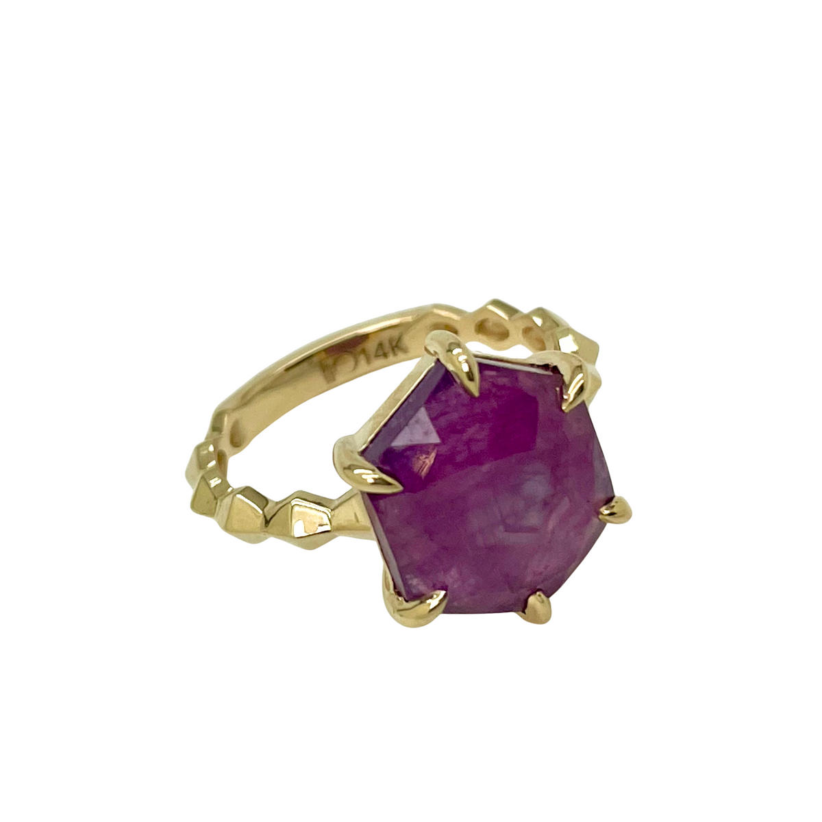 Gold ring with a ruby gemstone on a white background