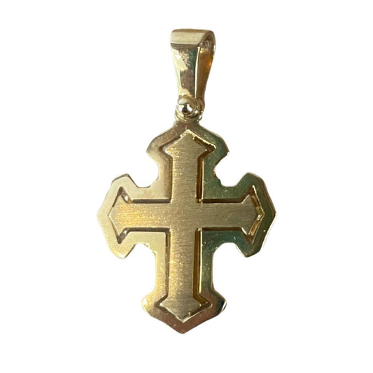 Gold cross pendant on a white background