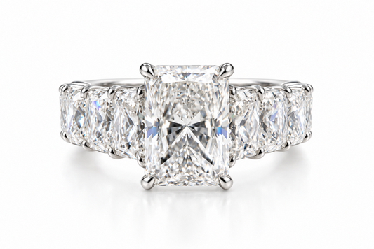 A radiant cut diamond engagement ring with a three-stone setting in a silver-colored metal, shown on a clean white background.