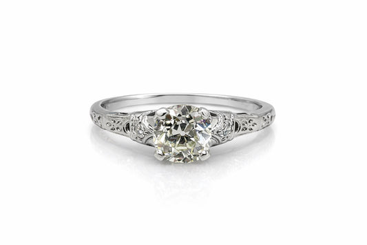 Diamond ring with intricate design on a white background