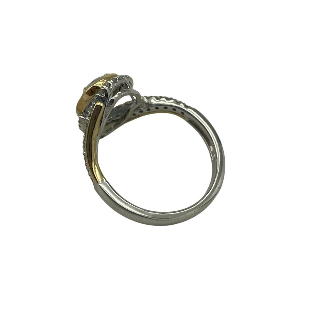 Silver ring with gold accents on a white background