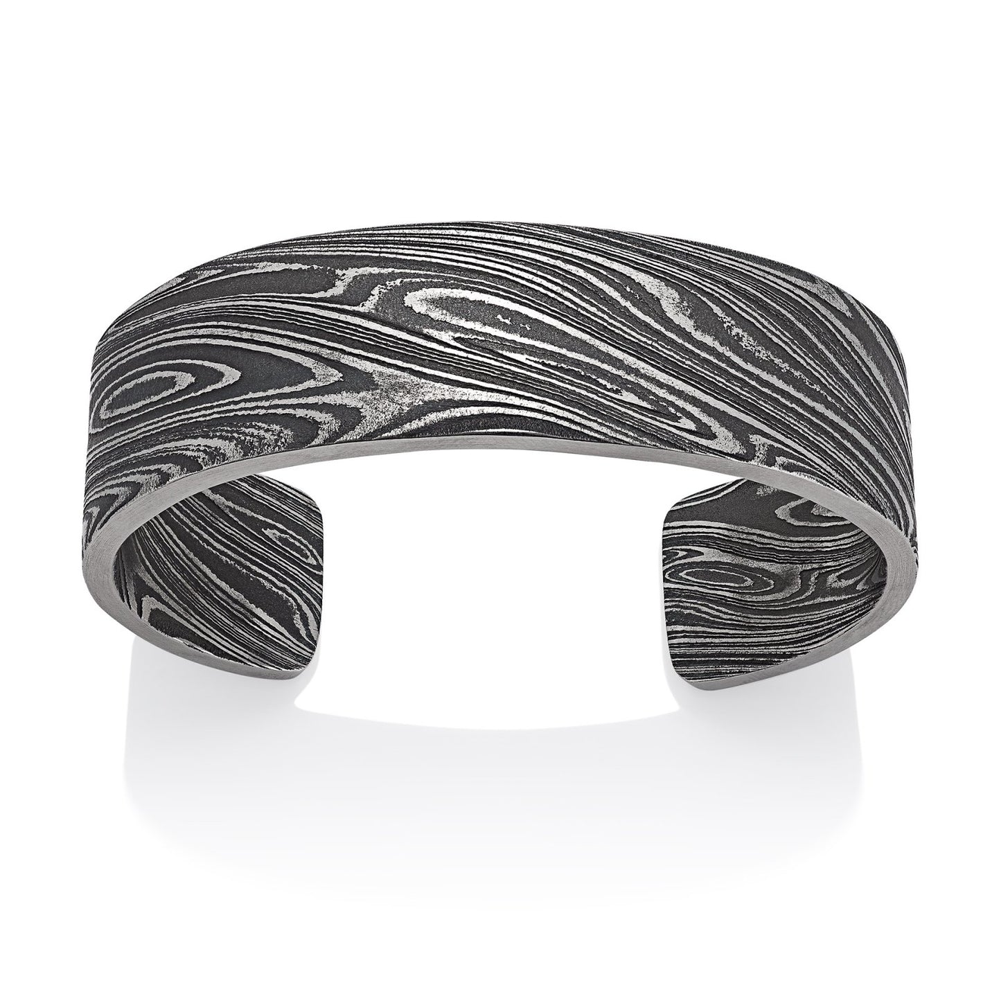 Titanium cuff bracelet with Damascus steel pattern on a white background.