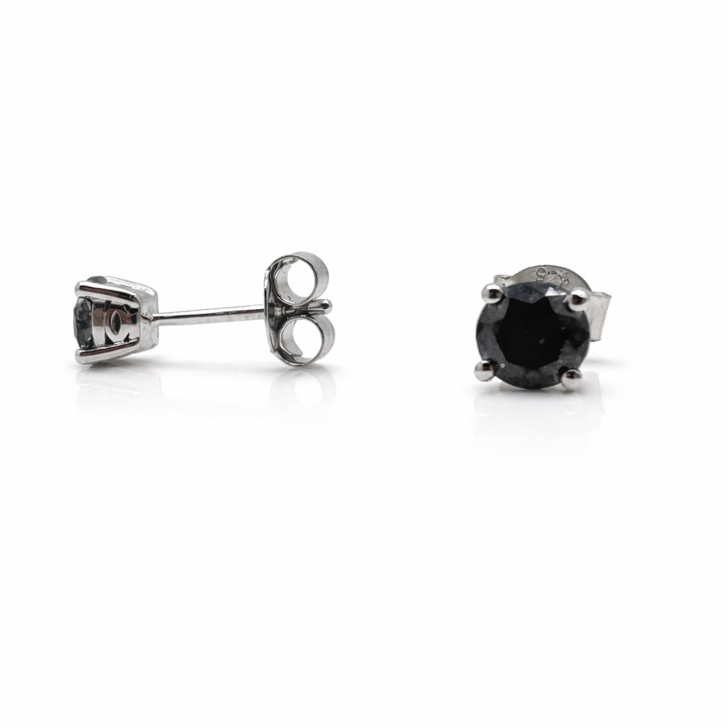 Pair of black gemstone stud earrings on a white background