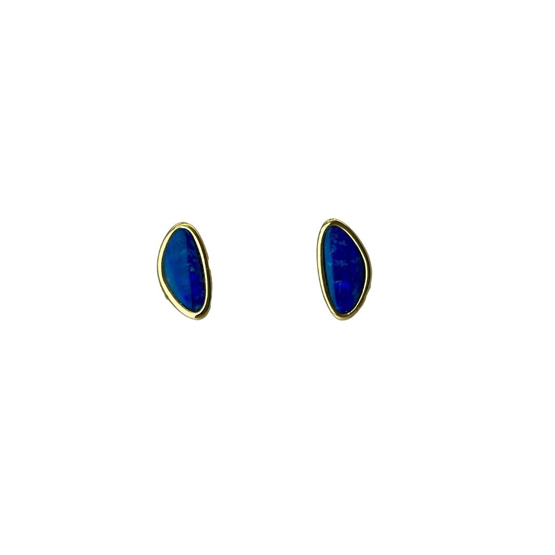 Pair of blue stone earrings with gold accents on a white background
