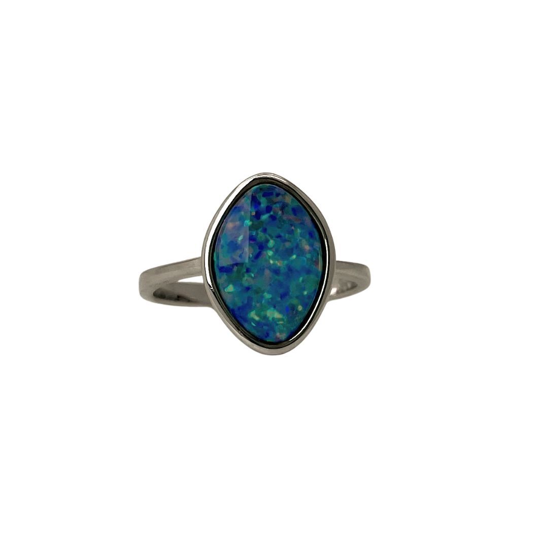 Silver ring with a blue opal stone on a white background