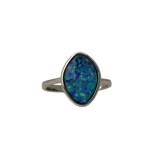 Silver ring with a blue opal stone on a white background