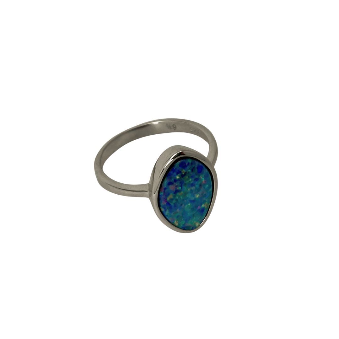Silver ring with a blue opal stone on a white background