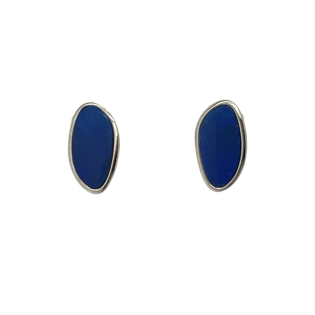 Pair of blue oval earrings with silver rims on a white background