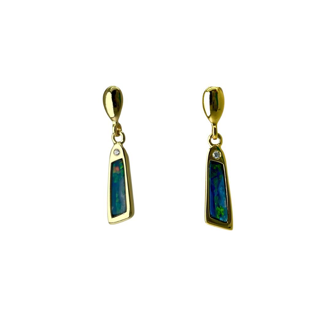 Pair of gold earrings with green gemstones on a white background