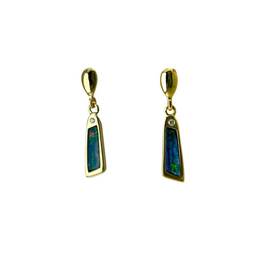 Pair of gold earrings with green gemstones on a white background