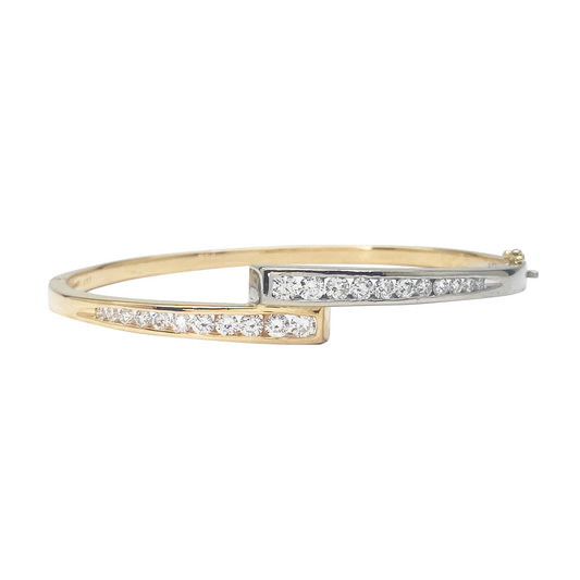 Gold and silver bracelet with embedded diamonds on a white background