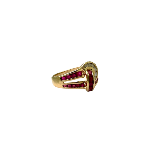 Gold ring with red gemstones on a white background