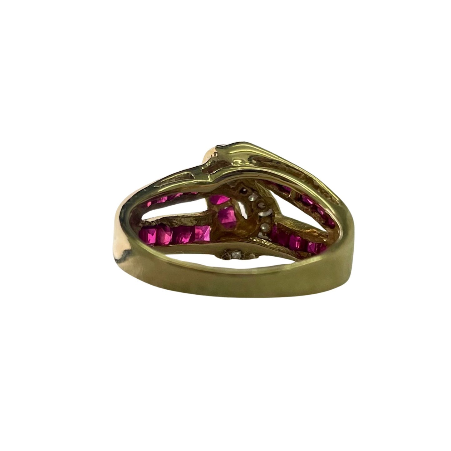 Gold ring with red gemstones on a white background