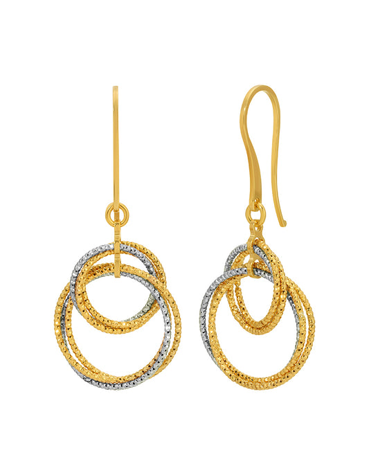 Gold and silver hoop earrings on a white background