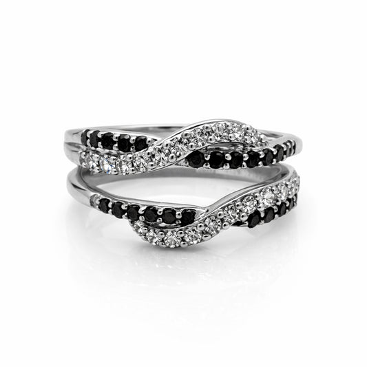 Pair of interlocking rings with black and clear gemstones on a white background