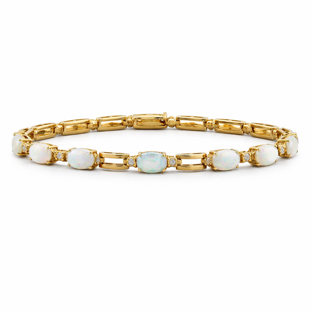Gold bracelet with opal stones on a white background