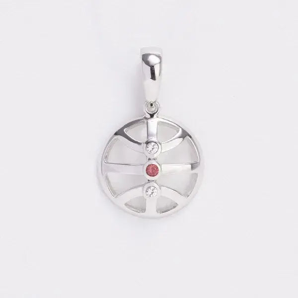 Silver pendant with a red gemstone on a white background