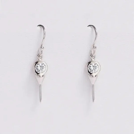 Pair of silver earrings with clear gemstones on a light gray background