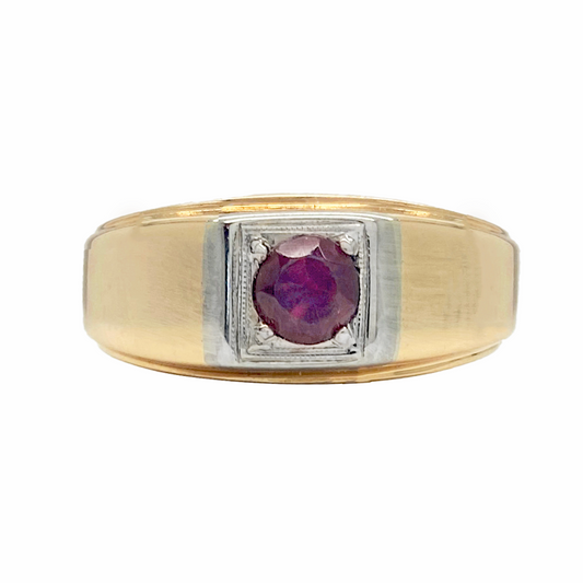 Two-tone men's ring with a red oval gemstone in the center. The ring has a wide band with a flat top and a grooved edge.