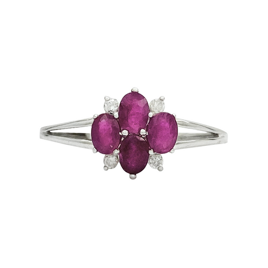 Front view of silver ring with a floral design featuring multiple rubies and diamonds on a white background