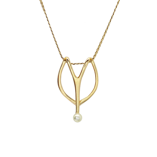 Gold pendant necklace with pearl on a white background
