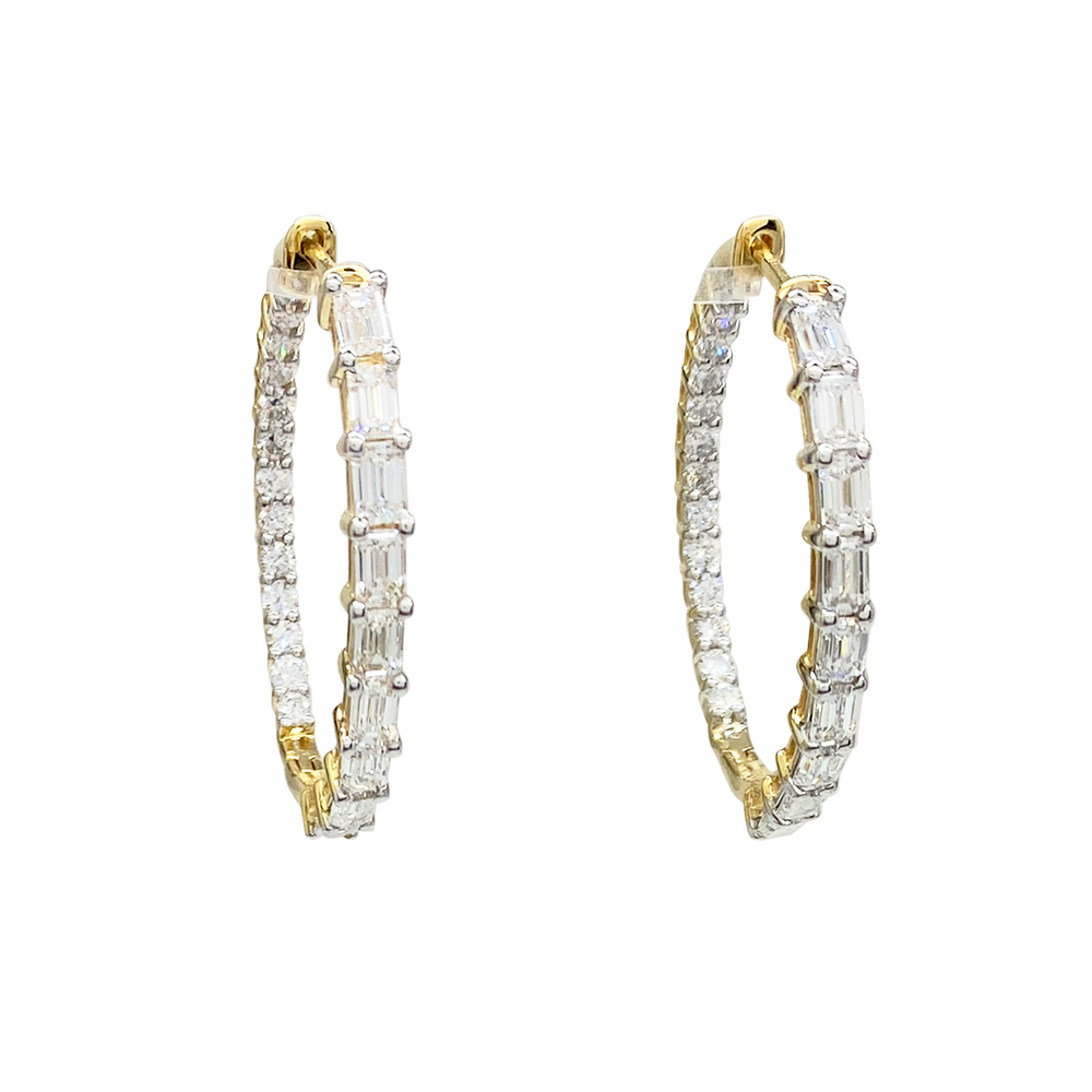 Yellow gold hoop earrings with alternating round and baguette-cut diamonds on a white background.