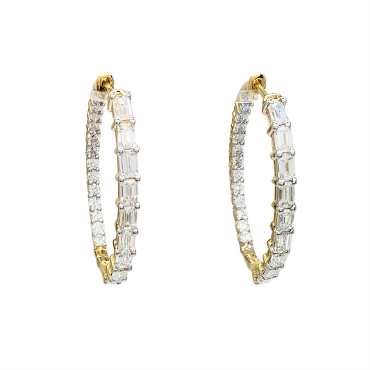 Yellow gold hoop earrings with alternating round and baguette-cut diamonds on a white background.