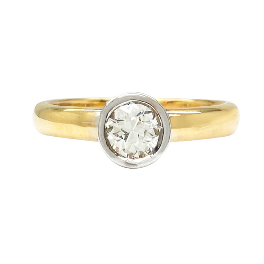 Yellow gold diamond engagement ring setting with a halo setting and a diamond-studded band, on a white background.