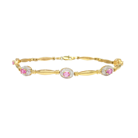 Gold bracelet with pink gemstones on a white background