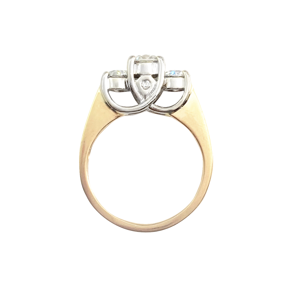 Yellow gold ring with three round diamonds in a three-stone setting, on a white background.