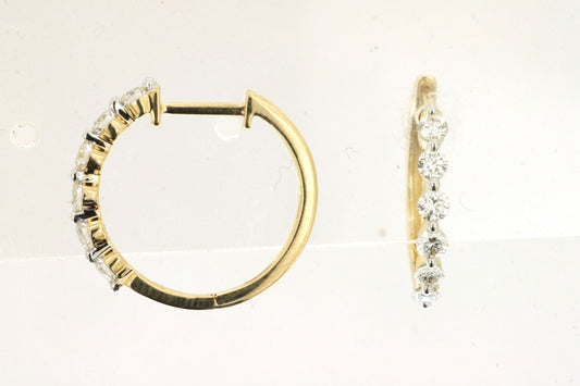 Gold hoop earrings with diamond accents on a light background