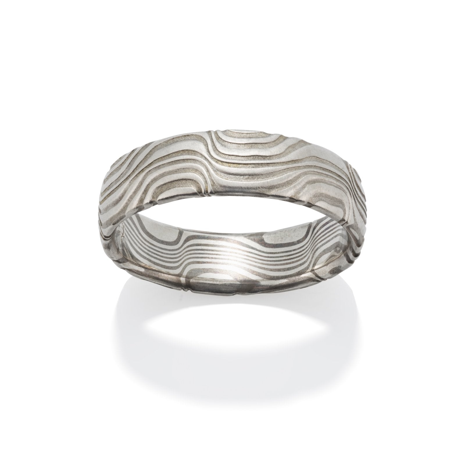 Damascus steel band ring on a white background