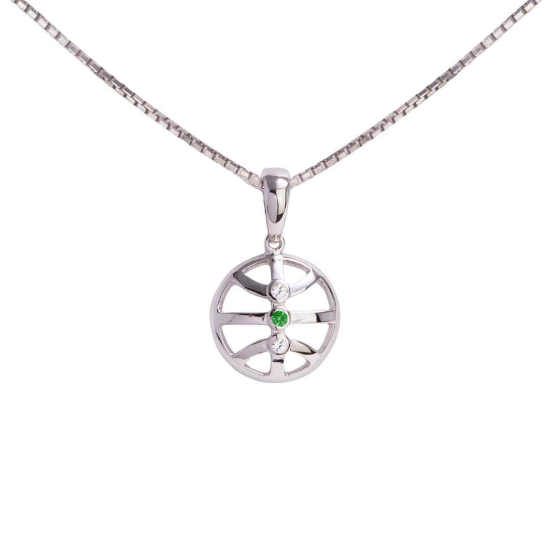 Silver pendant with a green gemstone on a white background