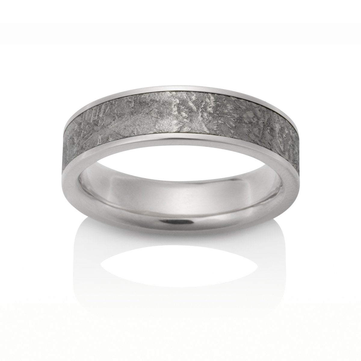 Silver ring with a meteorite inlay, on a white background.