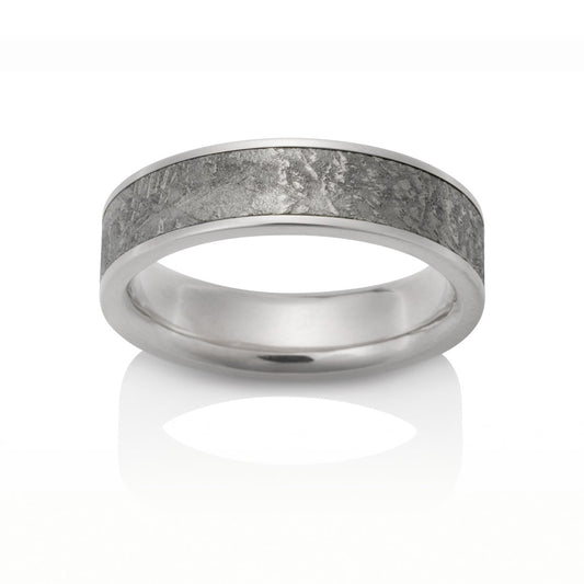 Silver ring with a meteorite inlay, on a white background.