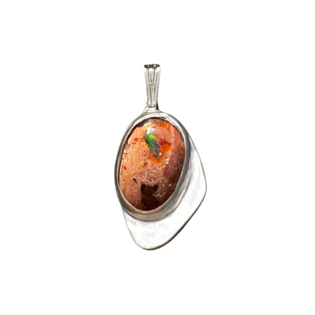 Silver pendant with a brown stone and green insect on a white background