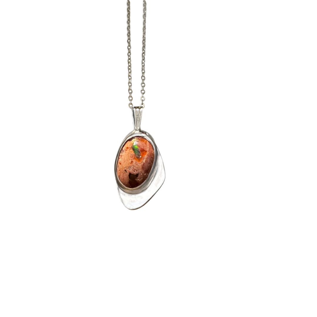 Silver pendant with a brown gemstone on a white background