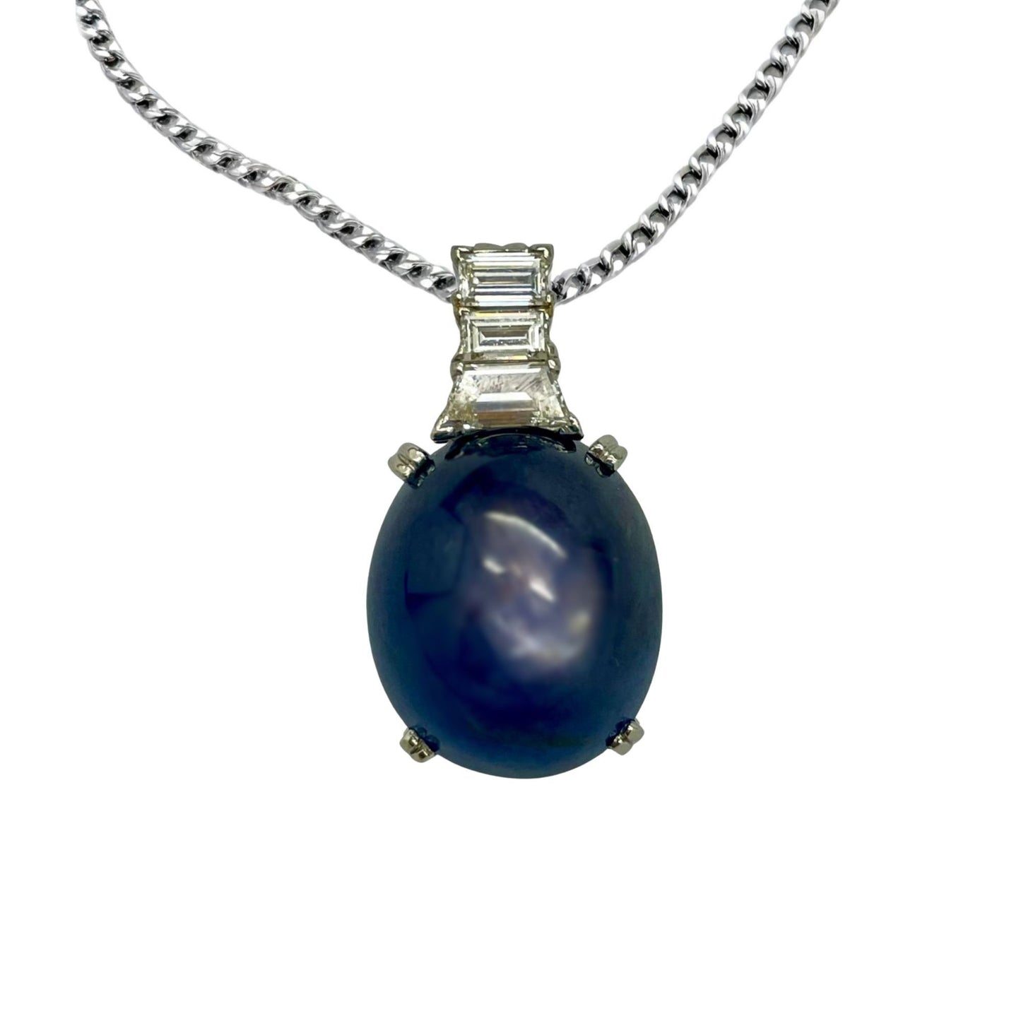 Blue sapphire gemstone pendant with silver chain on a white background