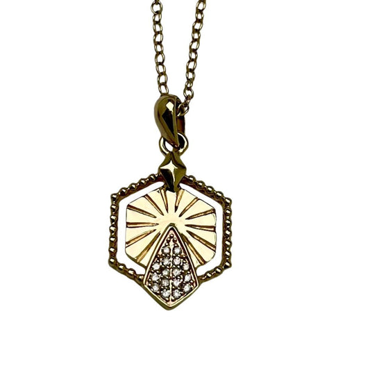 Gold necklace with a hexagonal pendant on a white background