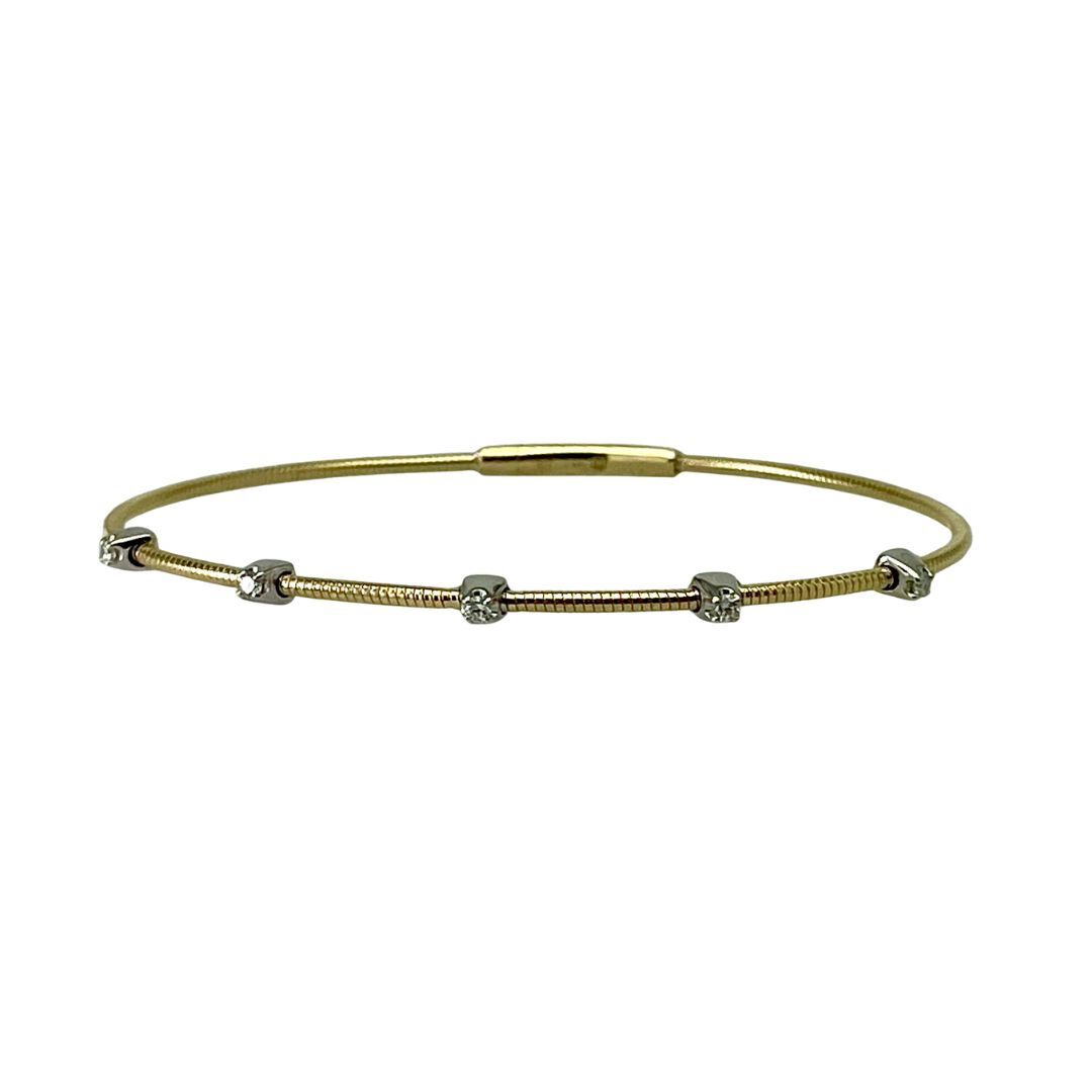 Gold bracelet with small beads on a white background