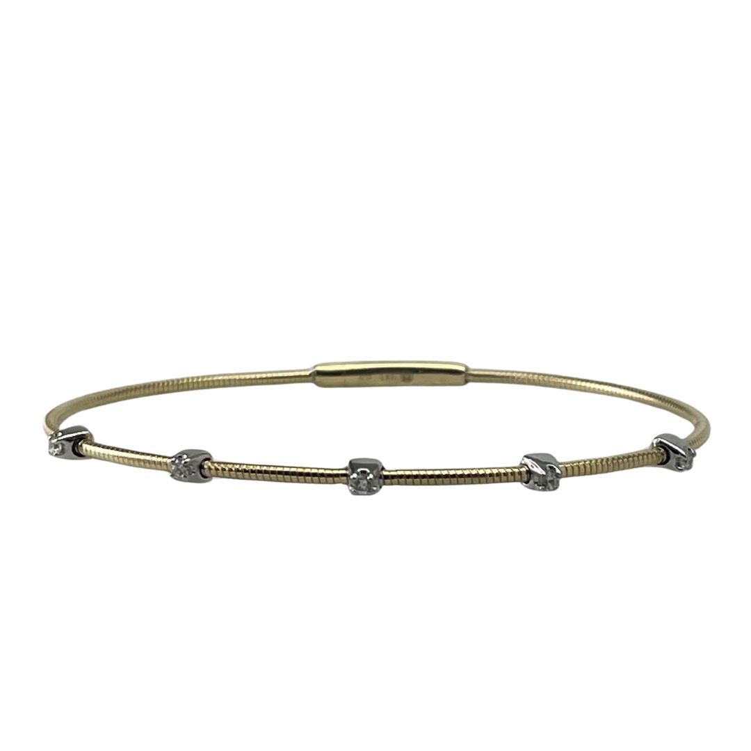 Gold bracelet with small beads on a white background