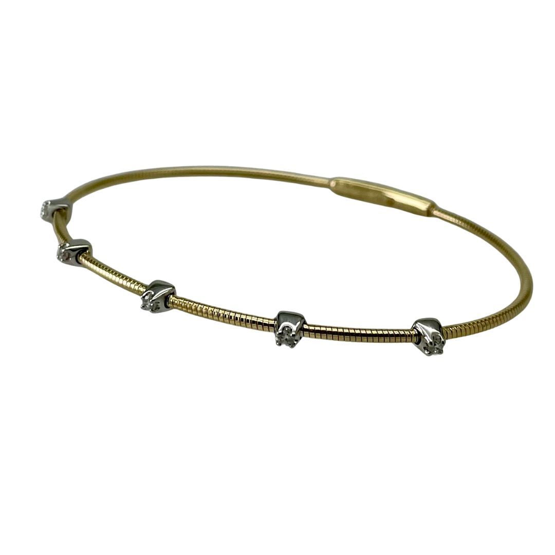 Gold bracelet with small silver beads on a white background