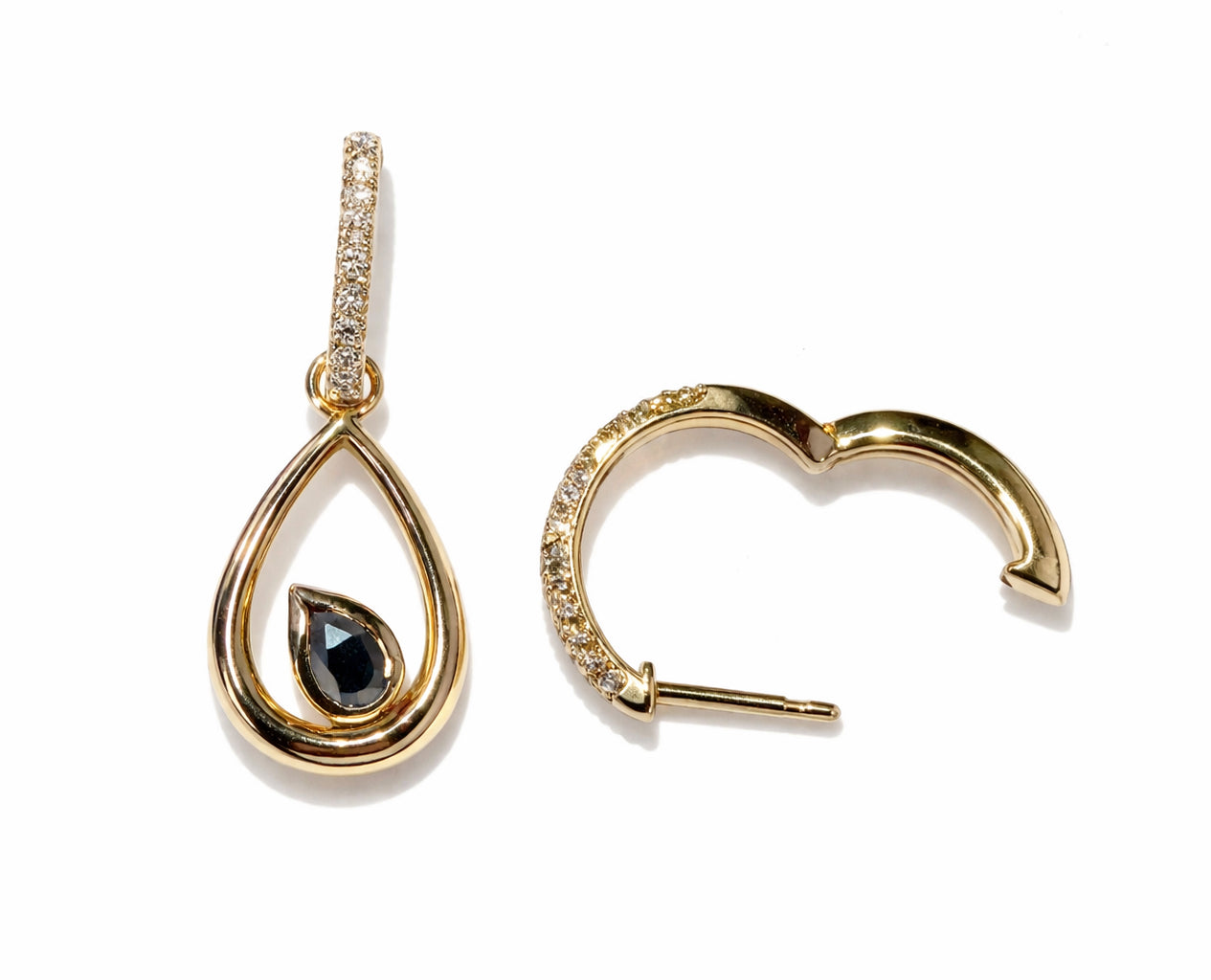 Gold teardrop earring with black gemstone and gold hoop earring on a white background