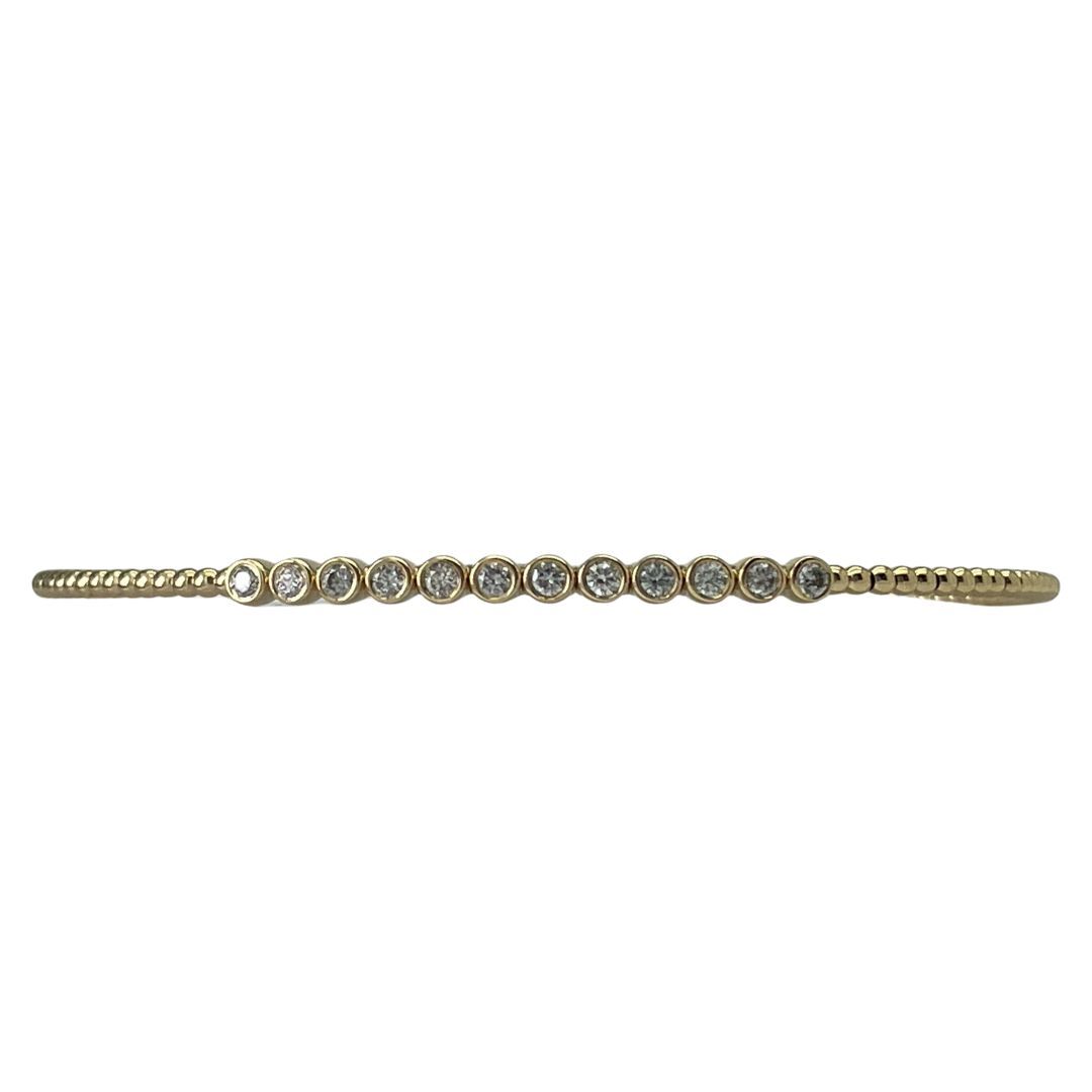 Gold bracelet with small diamonds on a white background