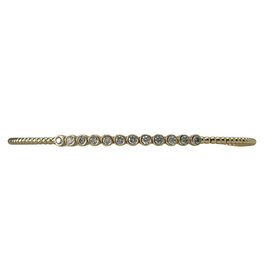Gold bracelet with small diamonds on a white background