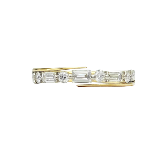 Gold ring with a variety of diamond cuts set horizontally across the band, including baguette, round, and oval shapes. The ring is photographed on a white background.